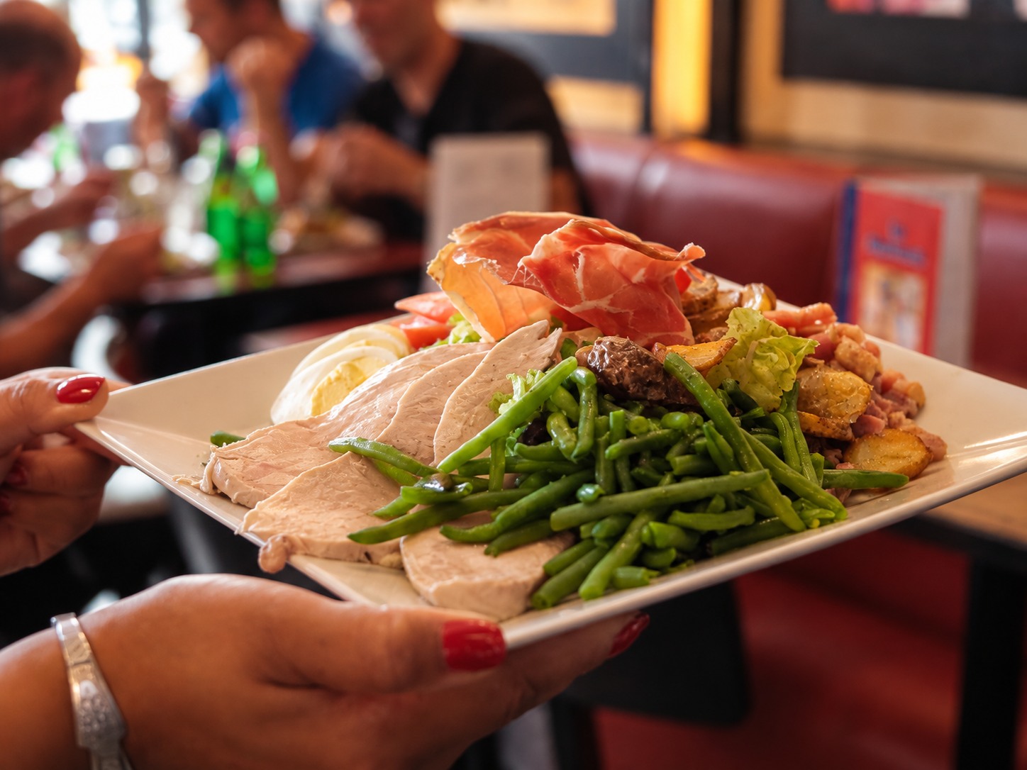 Assiette généreuse avec jambon cru, filet de canard, haricots verts et pommes de terre au restaurant Marivaux